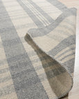 Handcrafted Vibrant Gray Flatweave Wool Rug, showcasing its flatweave construction and vibrant gray tones, sits in a bright living space, adding texture and subtle pattern to the hardwood floor.