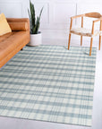 Handcrafted Vibrant Gray Flatweave Wool Rug in a bright, contemporary living room setting. The flatweave construction of this gray wool rug is visible beneath a modern coffee table, grounding the space with its subtle texture and vibrant hue.