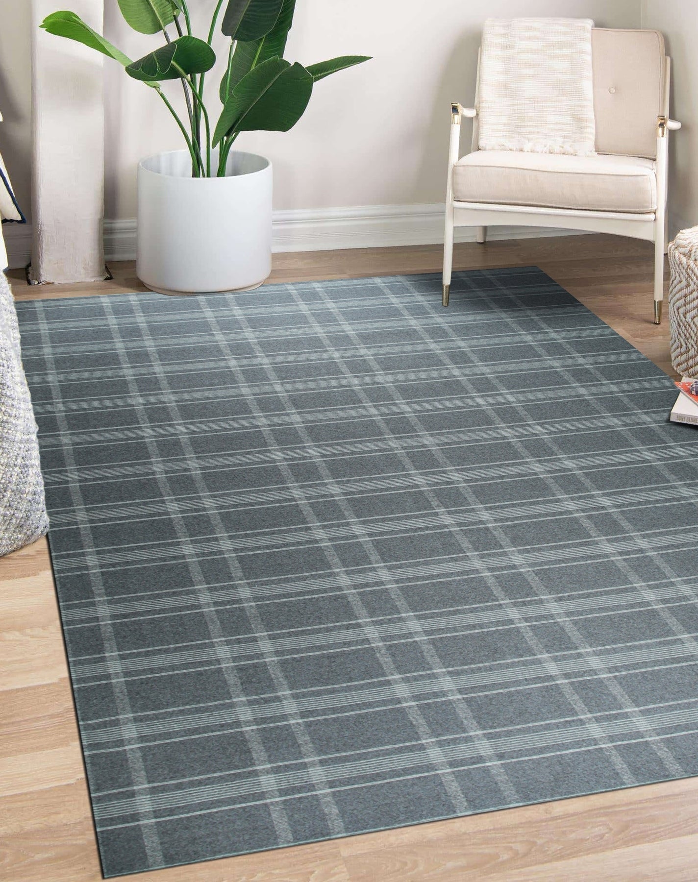 Graceful Quinn Gray Flatweave Wool Rug, soft gray wool underfoot in a warmly lit room. Modern geometric pattern dances across the flatweave texture, creating a subtly sophisticated foundation for the space.