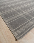 Graceful Quinn Gray Flatweave Wool Rug, showcasing its subtle geometric pattern and flatweave construction in a warmly lit interior setting.