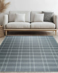 Graceful Quinn Gray Flatweave Wool Rug, showcasing its versatile gray tones and flatweave construction in a bright, modern living room setting with light wood floors.