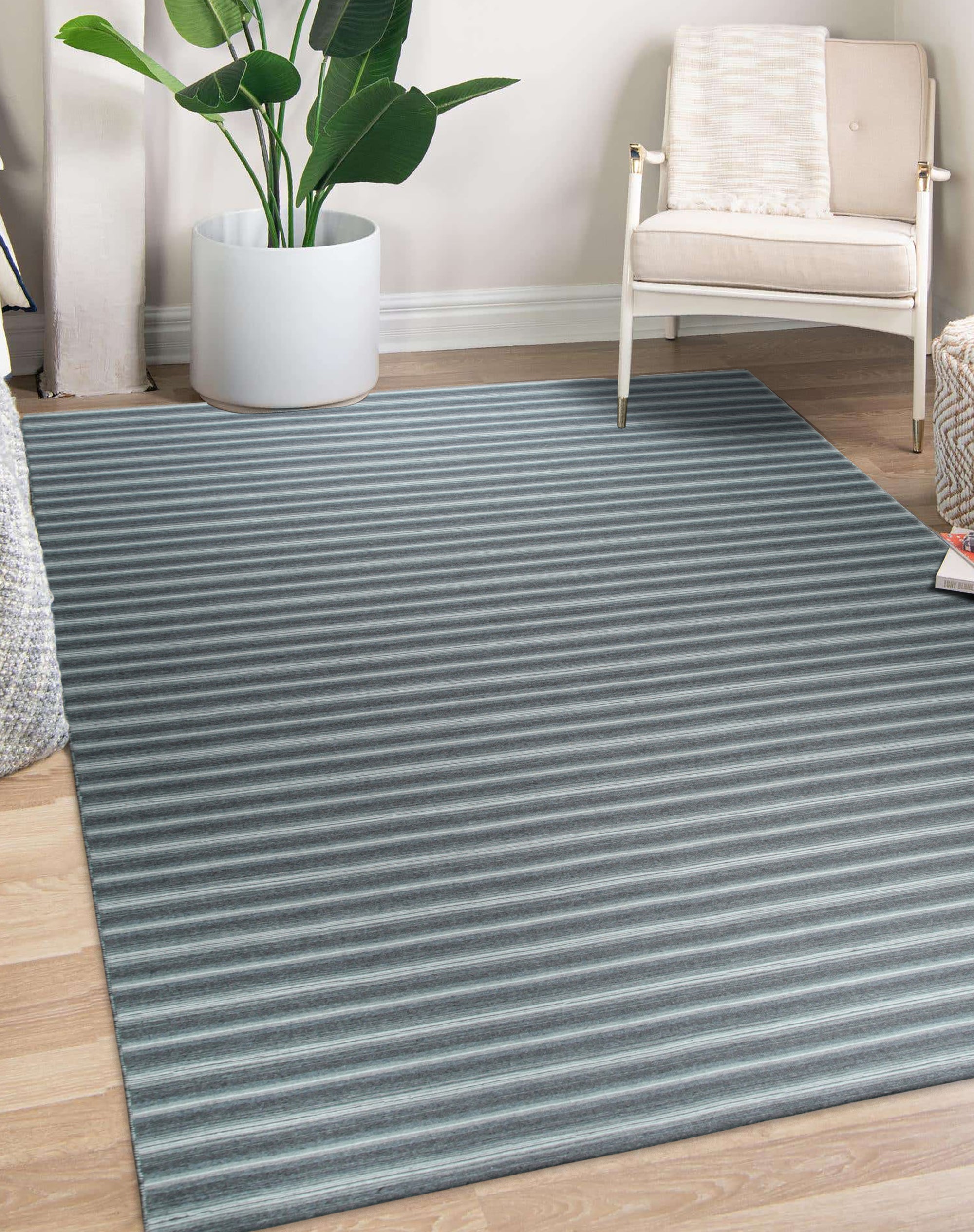 Lush Timeless Gray Flatweave Wool Rug in a bright living space; subtle gray tones and flatweave construction offer a modern, minimalist aesthetic.