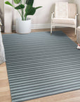 Lush Timeless Gray Flatweave Wool Rug in a bright living space; subtle gray tones and flatweave construction offer a modern, minimalist aesthetic.
