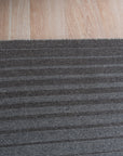 Timeless Comfortable Gray Flatweave Wool Rug, seen in a bright, inviting living room setting. Natural light highlights the subtle texture and cool gray tones of this flatweave wool rug, grounding a contemporary space.