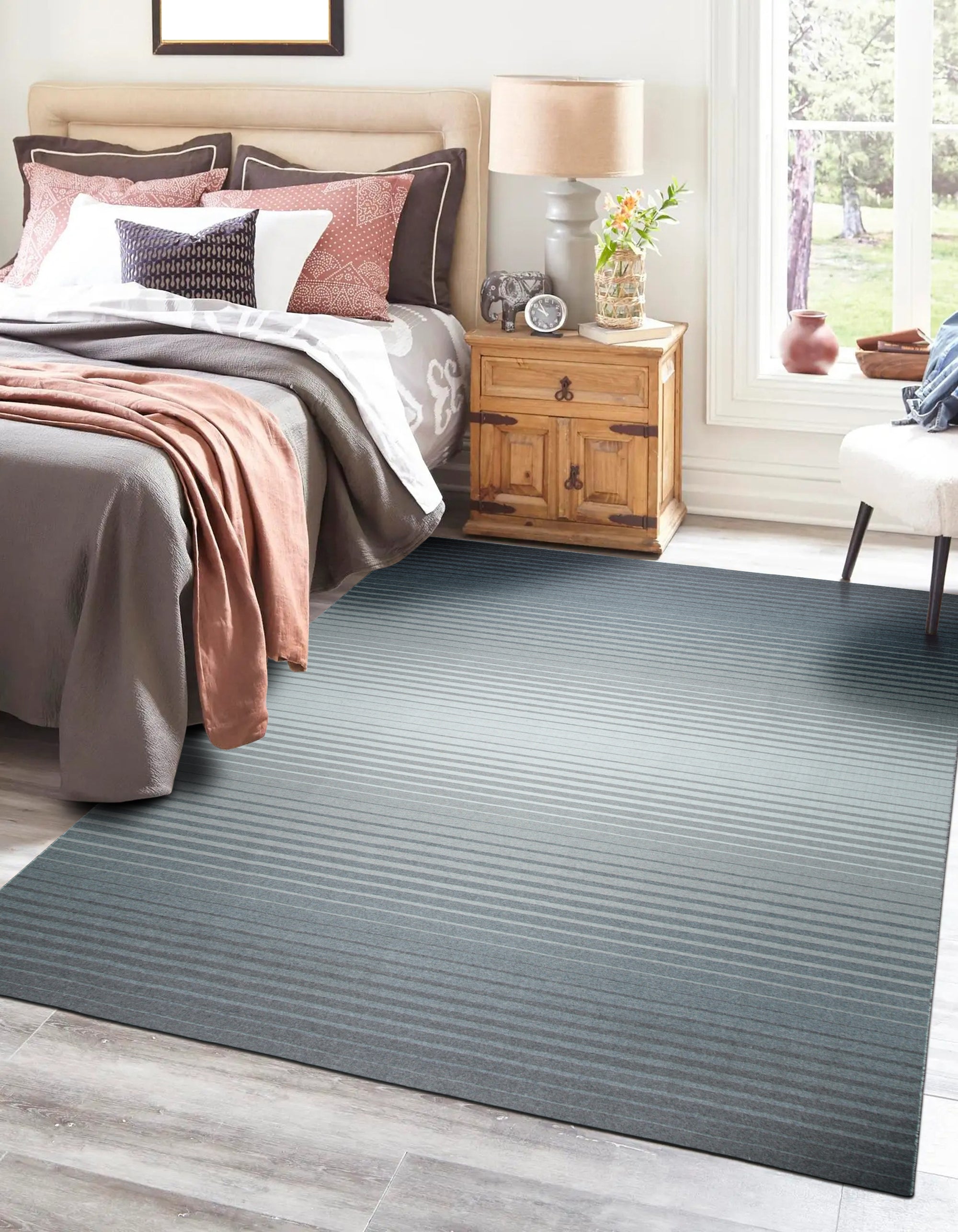 Timeless Comfortable Gray Flatweave Wool Rug, its subtle texture adding warmth to a bright, modern living room. Light wood furniture and natural light highlight the rug's soft gray tones and simple elegance.