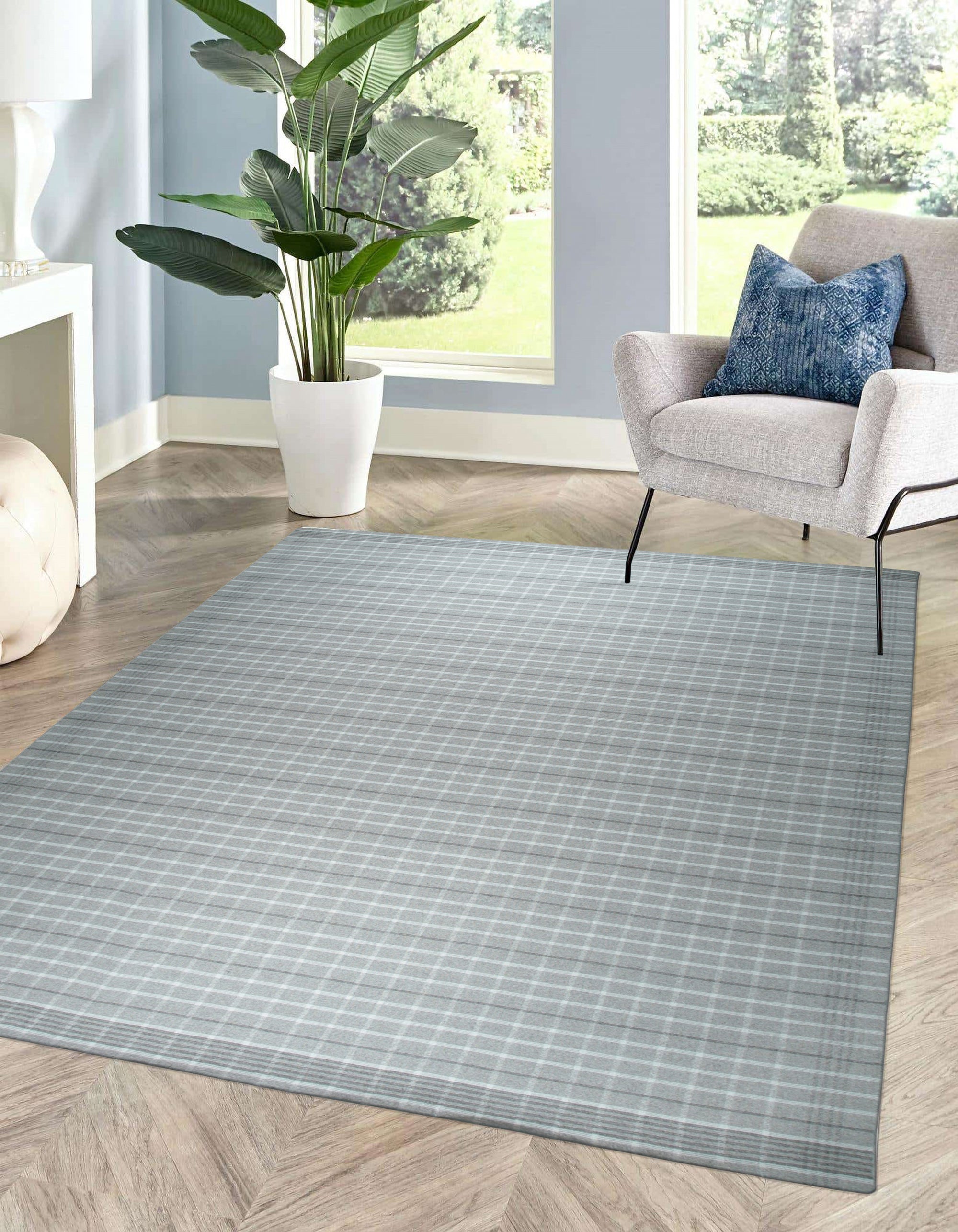 Timeless Celia Gray Flatweave Wool Rug, its subtle gray tones and flatweave construction blending seamlessly into a modern living room setting with light wood furniture and natural light.