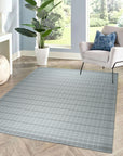 Timeless Celia Gray Flatweave Wool Rug, its subtle gray tones and flatweave construction blending seamlessly into a modern living room setting with light wood furniture and natural light.