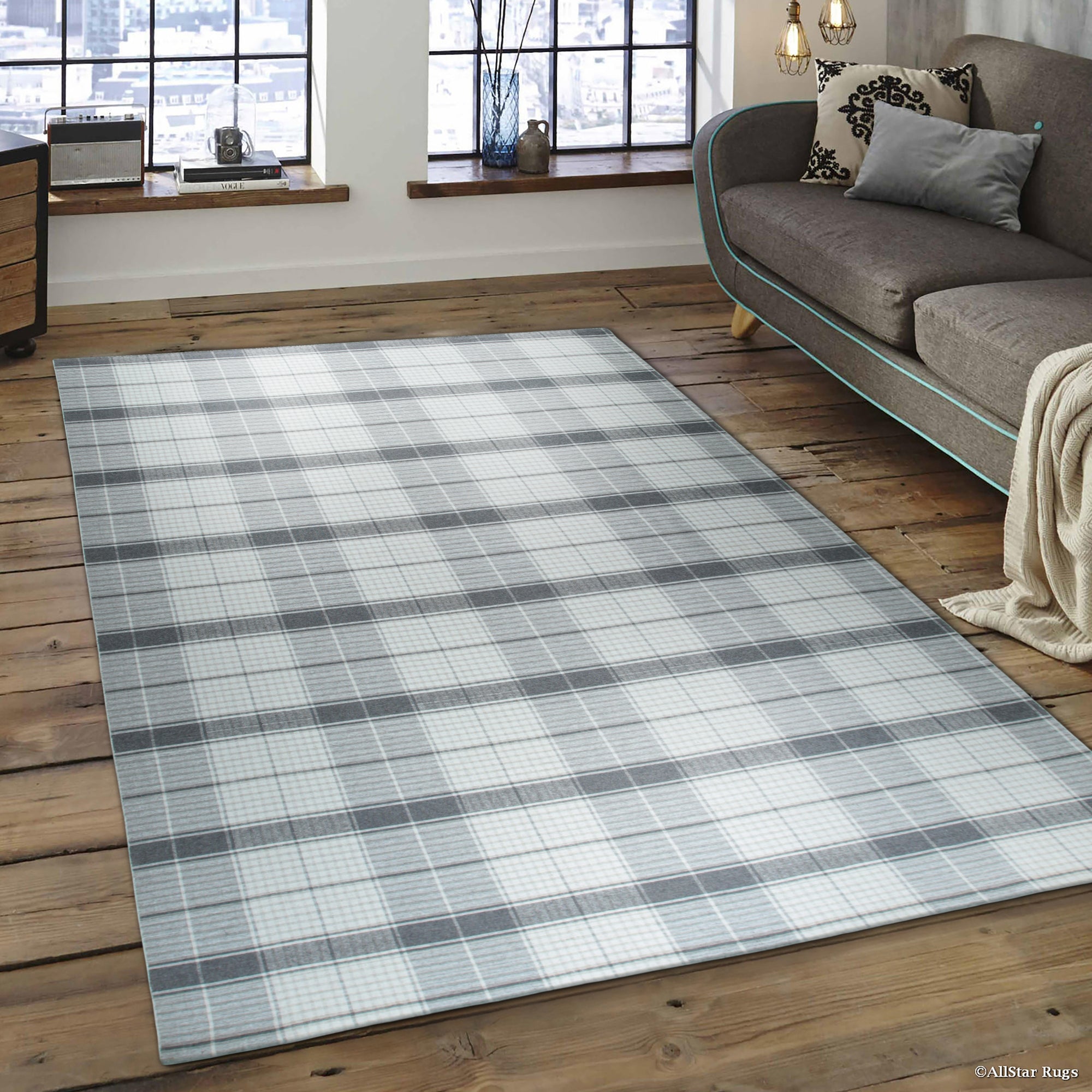 Lila Bianca Gray Flatweave Wool Rug displayed in a bright, modern living space. The gray and white wool rug anchors a seating area with a light-colored sofa and wooden coffee table, showcasing its simple, elegant design.