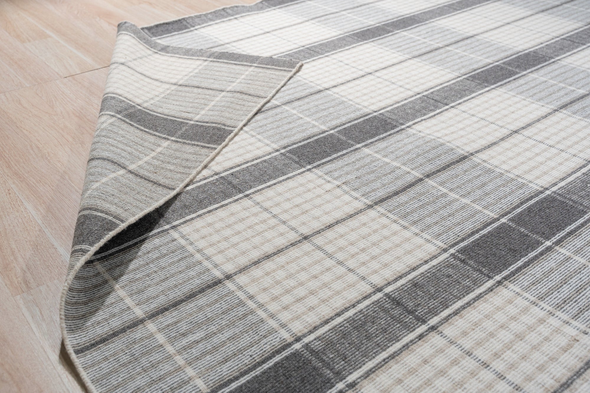 Lila Bianca Gray Flatweave Wool Rug, its textured flatweave design adding subtle sophistication to a modern living space.