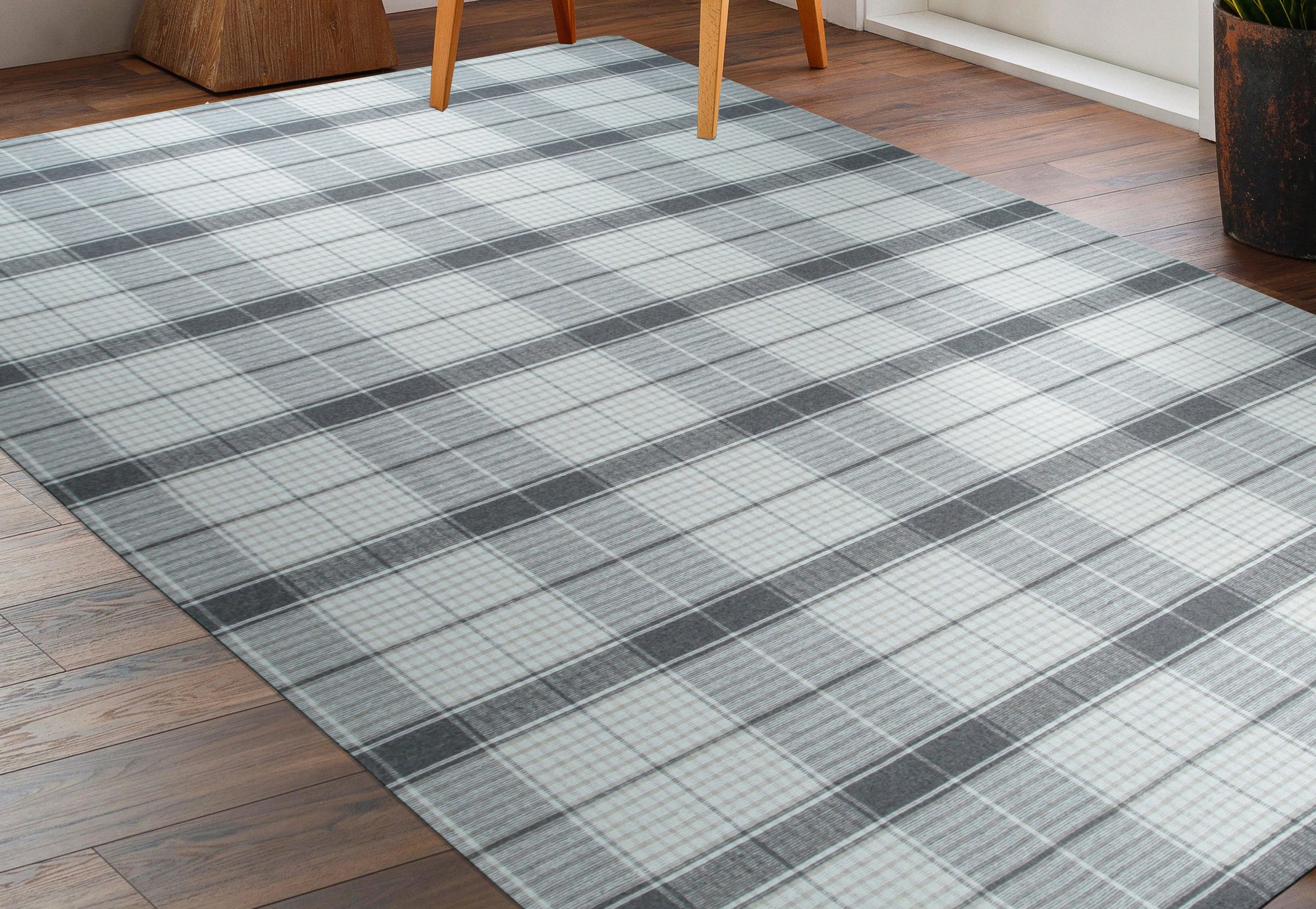 Lila Bianca Gray Flatweave Wool Rug in a bright living room setting; its geometric pattern blends seamlessly with modern furniture and warm wood tones, illustrating its versatility.