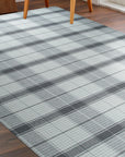 Lila Bianca Gray Flatweave Wool Rug in a bright living room setting; its geometric pattern blends seamlessly with modern furniture and warm wood tones, illustrating its versatility.