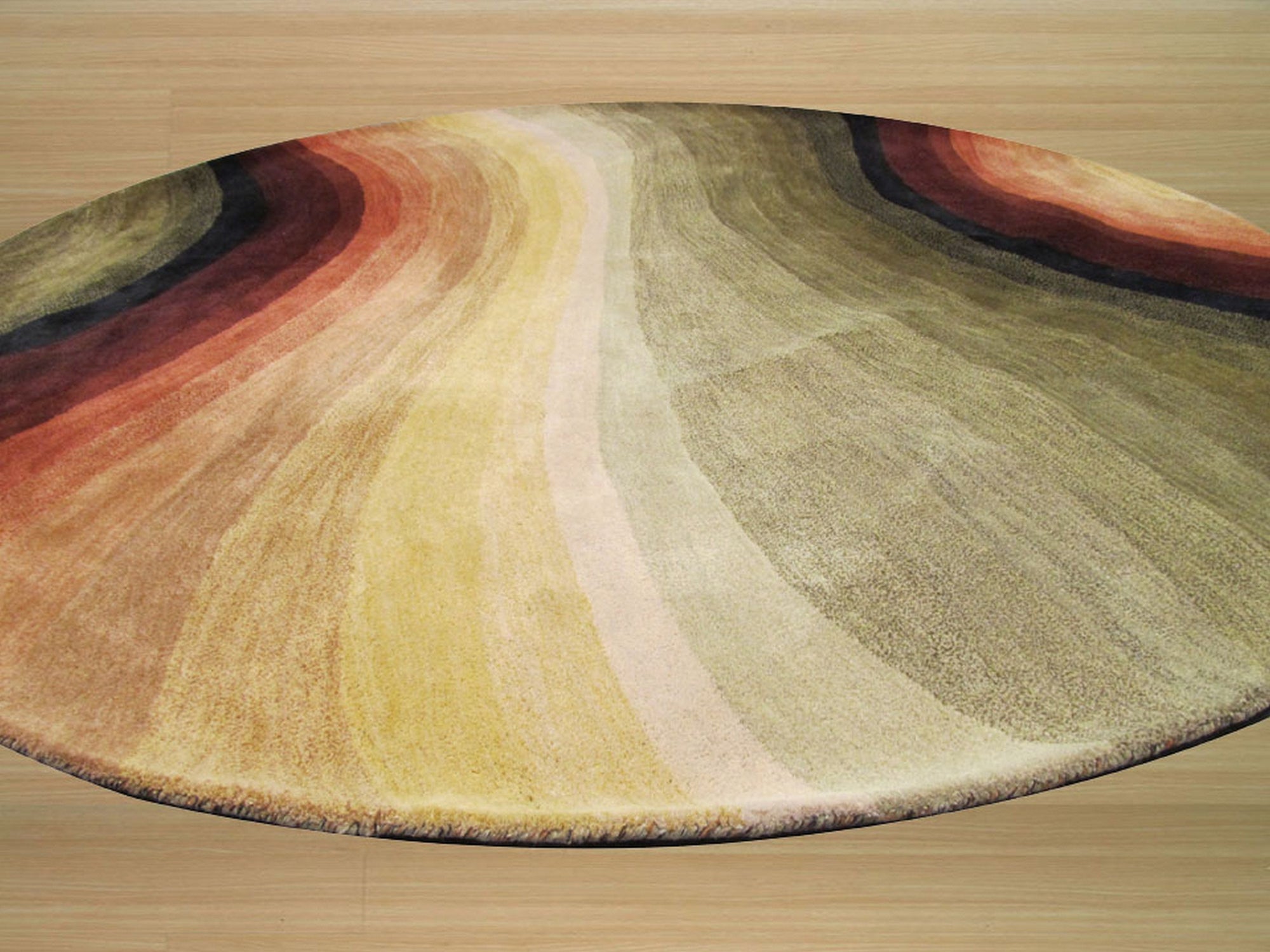 Stylish Sloane Multicolor Hand Tufted Wool Rug, blending vibrant hues in a contemporary design, anchors a living room with warm wood floors and natural light, showcasing its texture and detail.