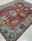 Mira Traditional Rust Hand Knotted Wool Rug, showcasing a detailed, warm rust-toned pattern. The hand-knotted construction and intricate design details are clearly visible, highlighting its traditional style.