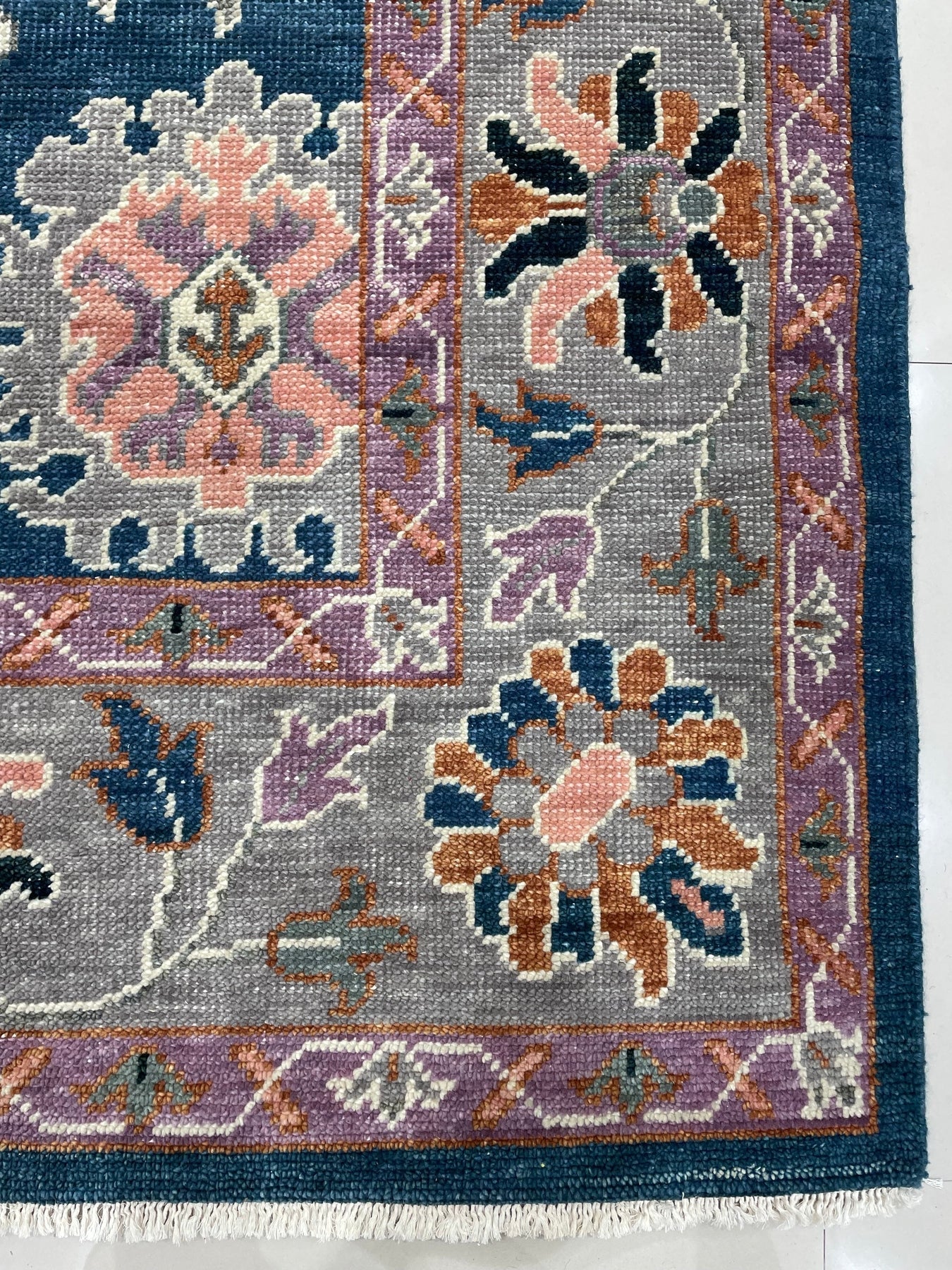 Unique Rustic Blue Hand Knotted Wool Rug, a richly textured wool rug with distressed blues and creams, lies flat, suggesting warmth and handcrafted quality.
