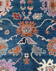 Unique Rustic Blue Hand Knotted Wool Rug, showcasing a blend of cool blues and rustic textures, hand-knotted wool construction creating depth and visual interest in a living room setting.