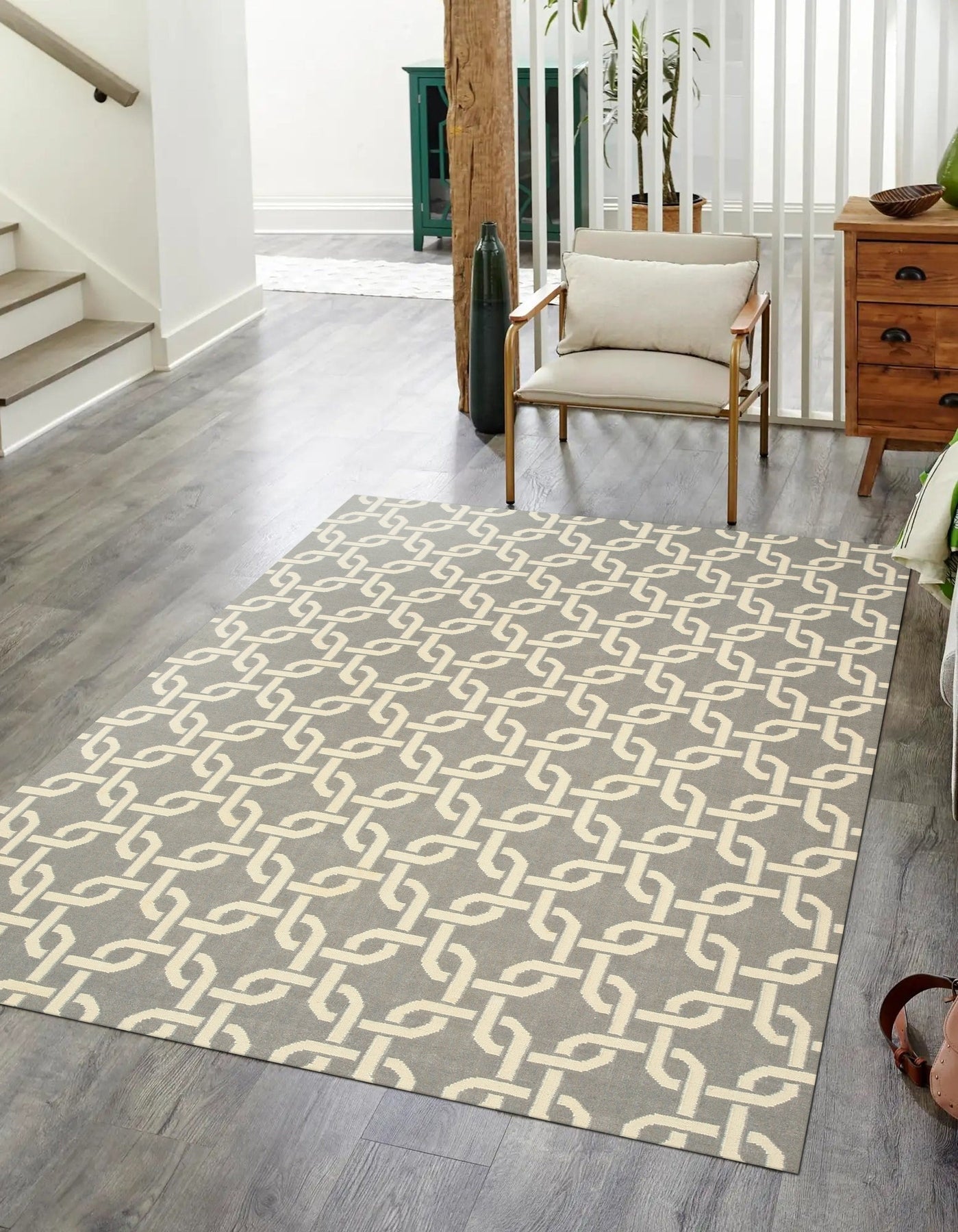 Sloane Cozy Grey Flatweave Wool Rug, a neutral foundation anchoring a contemporary living space, its flatweave construction lending a subtle texture underfoot, light and airy, complemented by natural light and modern furniture.
