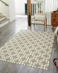 Sloane Cozy Grey Flatweave Wool Rug, a neutral foundation anchoring a contemporary living space, its flatweave construction lending a subtle texture underfoot, light and airy, complemented by natural light and modern furniture.