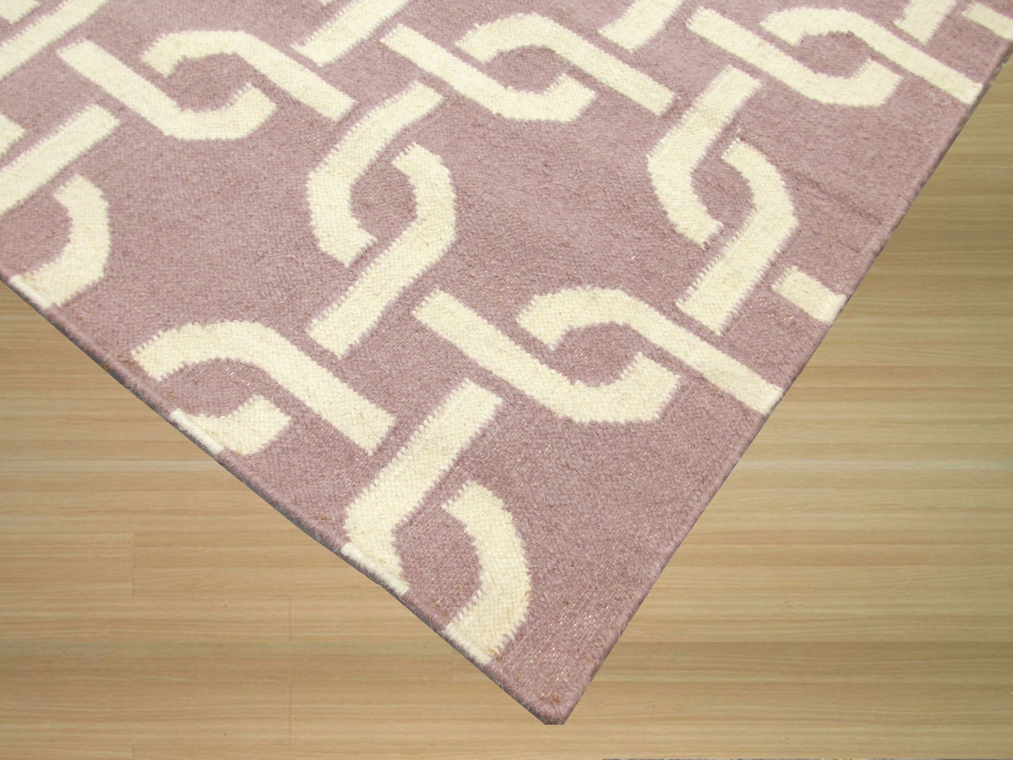 Sloane Cozy Pink Flatweave Wool Rug, soft pink hues and subtle texture grace a minimalist living space, highlighting the rug's warm wool construction.