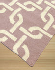 Sloane Cozy Pink Flatweave Wool Rug, soft pink hues and subtle texture grace a minimalist living space, highlighting the rug's warm wool construction.