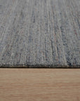 Isla Trendy Blue Handmade Wool Rug, showcasing a contemporary abstract design with swirling blues, creams, and touches of warm hues, creating a soft and inviting texture.