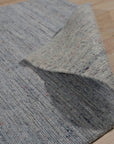 Isla Trendy Blue Handmade Wool Rug, features a dynamic abstract design in shades of blue and cream, creating a modern focal point for any room.