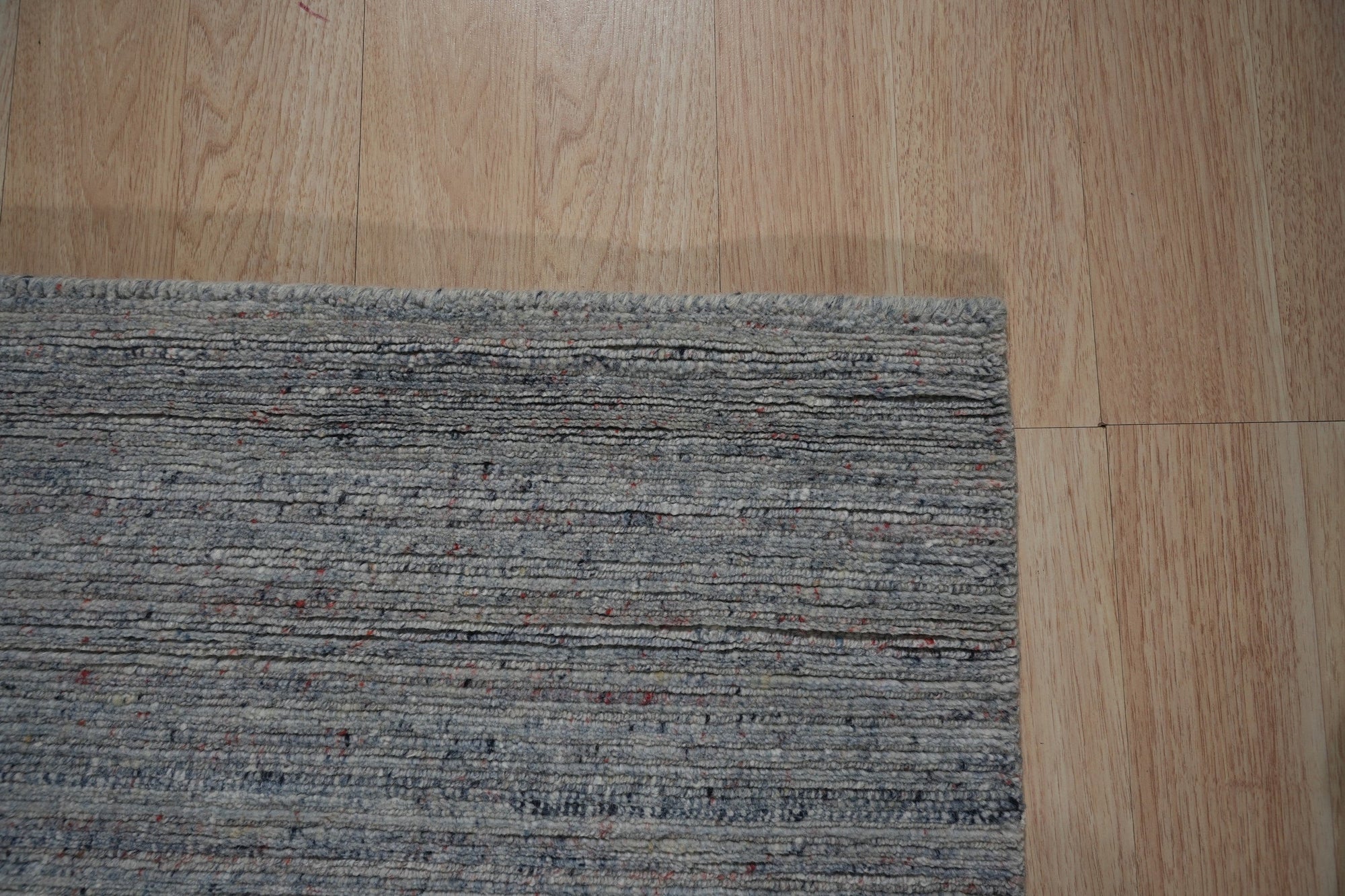 Isla Trendy Blue Handmade Wool Rug, a vibrant blue and cream wool rug with a geometric pattern, seen in a bright living room setting.
