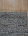 Isla Trendy Blue Handmade Wool Rug, a vibrant blue and cream wool rug with a geometric pattern, seen in a bright living room setting.