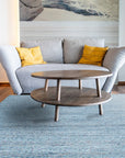 Isla Trendy Blue Handmade Wool Rug, vibrant blue and cream tones blend in a dynamic, abstract pattern under a modern living room setting, showcasing its plush wool texture and hand-made construction.