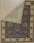 Bespoke Oushak Gray Hand Knotted Wool Rug, featuring intricate floral patterns in soft grays and creams, displayed in a bright, modern living room setting with neutral furniture.