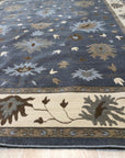Bespoke Oushak Gray Hand Knotted Wool Rug, its delicate, traditional Oushak pattern unfolding in calming grays, resting in a softly lit interior.