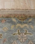 Classic Oushak Beige Hand Knotted Wool Rug displayed in a living room setting, its subtle beige tones complementing neutral furniture and creating a warm, inviting atmosphere.