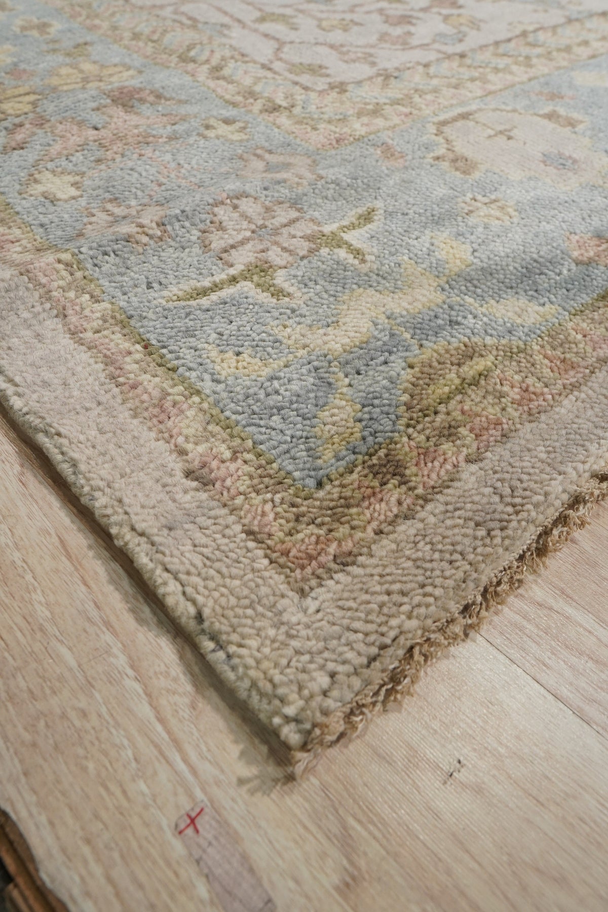 Classic Oushak Beige Hand Knotted Wool Rug, a warm beige wool rug with a traditional Oushak design, seen in a bright, contemporary living room setting.