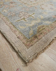 Classic Oushak Beige Hand Knotted Wool Rug, a warm beige wool rug with a traditional Oushak design, seen in a bright, contemporary living room setting.