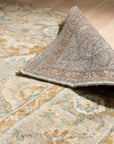 Freya Oushak Green Hand Knotted Wool Rug, its verdant hues and intricate floral patterns gracefully unfurling across a softly lit floor, inviting warmth and artisanal charm into the space.