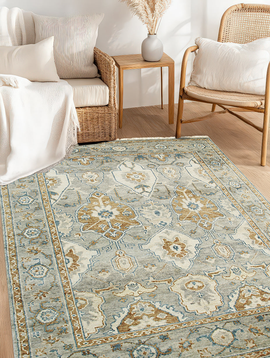 Freya Oushak Green Hand Knotted Wool Rug, a calming green wool rug with intricate floral motifs and a subtly distressed texture, adding warmth and elegance to a well-lit living space.