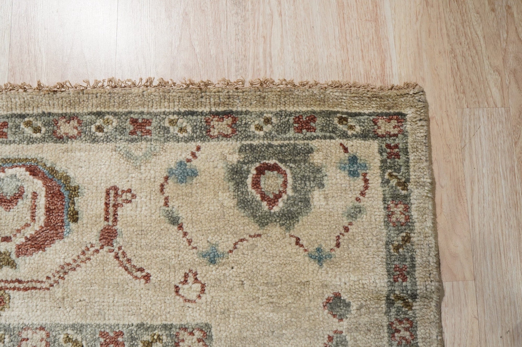 Versatile Oushak Ivory Hand Knotted Wool Rug, showcasing its intricate floral design and soft ivory tones in a bright, airy living space.