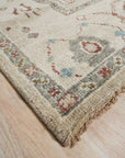 Versatile Oushak Ivory Hand Knotted Wool Rug gracing a light-filled living space, its soft ivory tones and traditional Oushak pattern lending warmth and subtle elegance to the room.