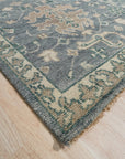 Beautiful Oushak Blue Hand Knotted Wool Rug, its intricate floral patterns and soft blue hues creating a serene atmosphere in a bright living room setting.