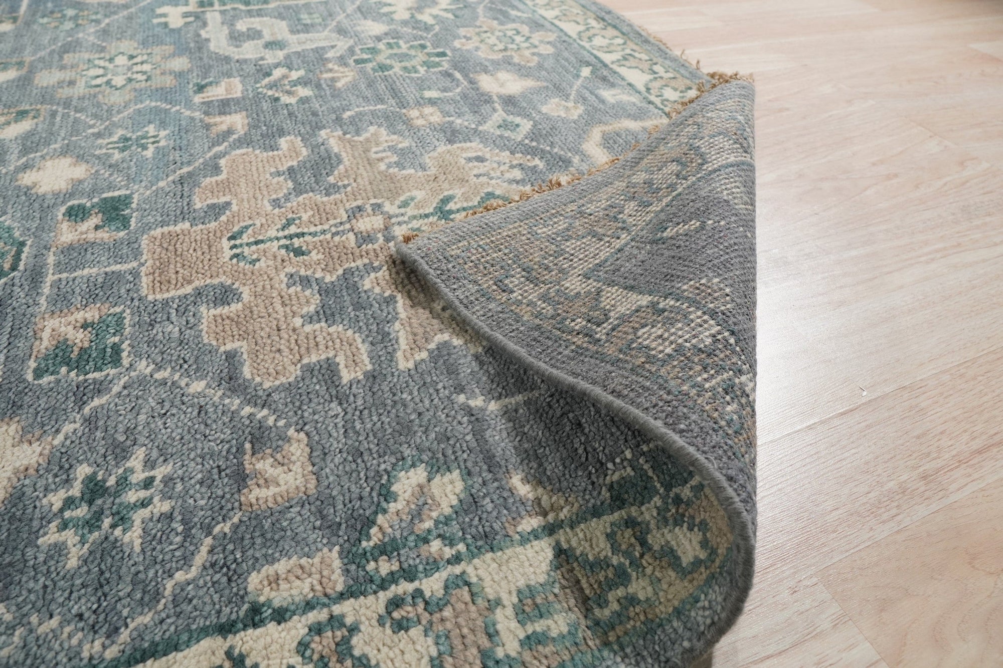 Beautiful Oushak Blue Hand Knotted Wool Rug, a calming blue wool rug with a traditional Oushak pattern, seen in a bright, airy room.