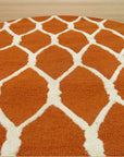 Amara Delicate Orange Hand Tufted Wool Rug, blending warm orange tones in a hand-tufted wool construction, seen in a bright, airy setting.