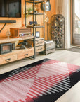 Dazzling Sleek Red Flatweave Wool Rug, its rich red hue and flatweave texture grounding a brightly lit living space with modern furniture and potted plants.