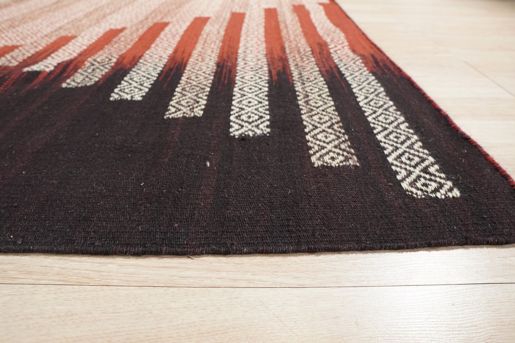 Dazzling Sleek Red Flatweave Wool Rug, a vibrant expanse of crimson wool with a subtle, flatweave texture, nestled within a bright and airy living space, anchoring a modern seating arrangement.