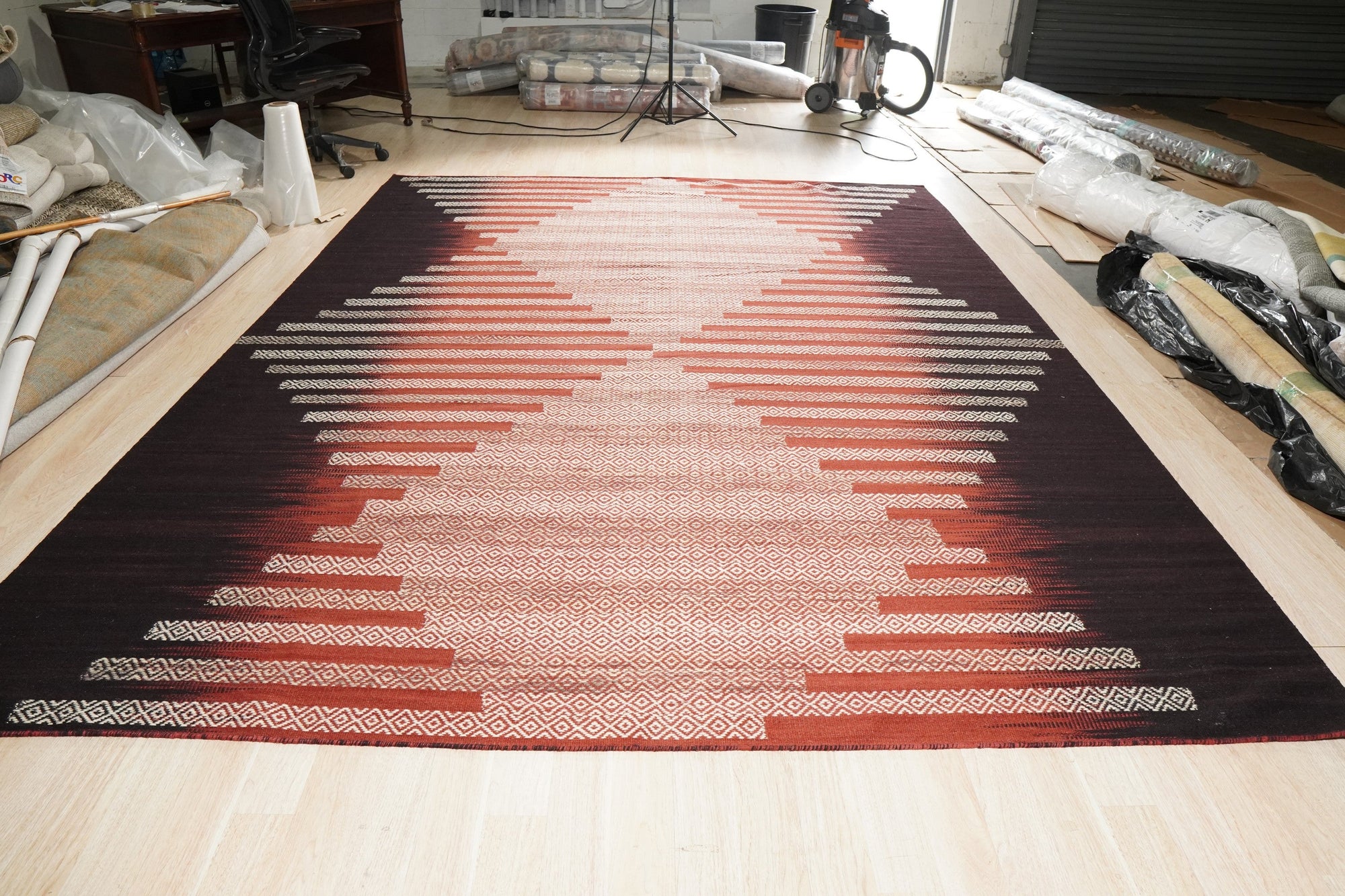 Dazzling Sleek Red Flatweave Wool Rug, vibrant red flatweave catches the light, its subtle texture adding depth to a modern living room setting.