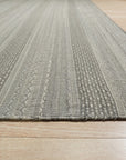 Captivating Talia Gray Handmade Wool Rug, a soft gray wool rug with a subtle, textural design, displayed in a bright living room setting.