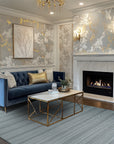 Captivating Talia Gray Handmade Wool Rug, showcasing a textured gray wool field with subtle geometric patterns, lending a sophisticated and inviting feel to a living room setting.