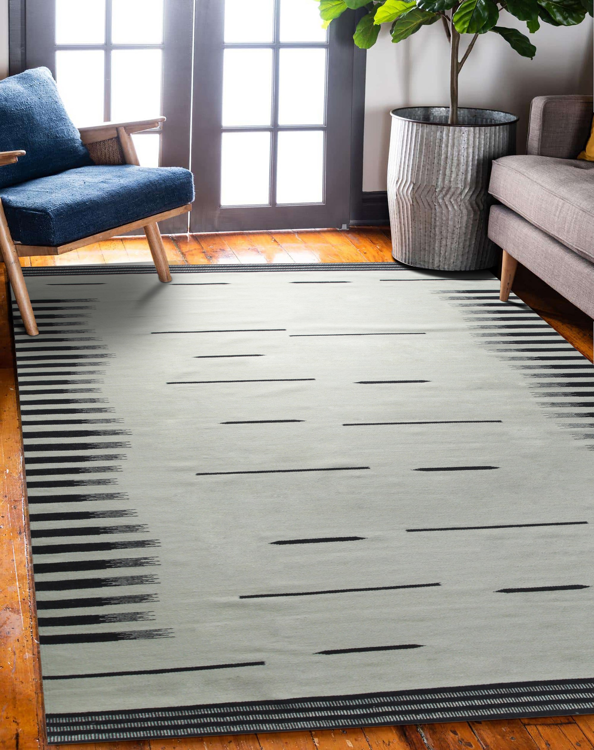 Sloane Majestic Gray Flatweave Wool Rug, showcasing its flatweave construction and subtle gray tones within a modern living room setting.