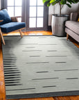 Sloane Majestic Gray Flatweave Wool Rug, showcasing its flatweave construction and subtle gray tones within a modern living room setting.