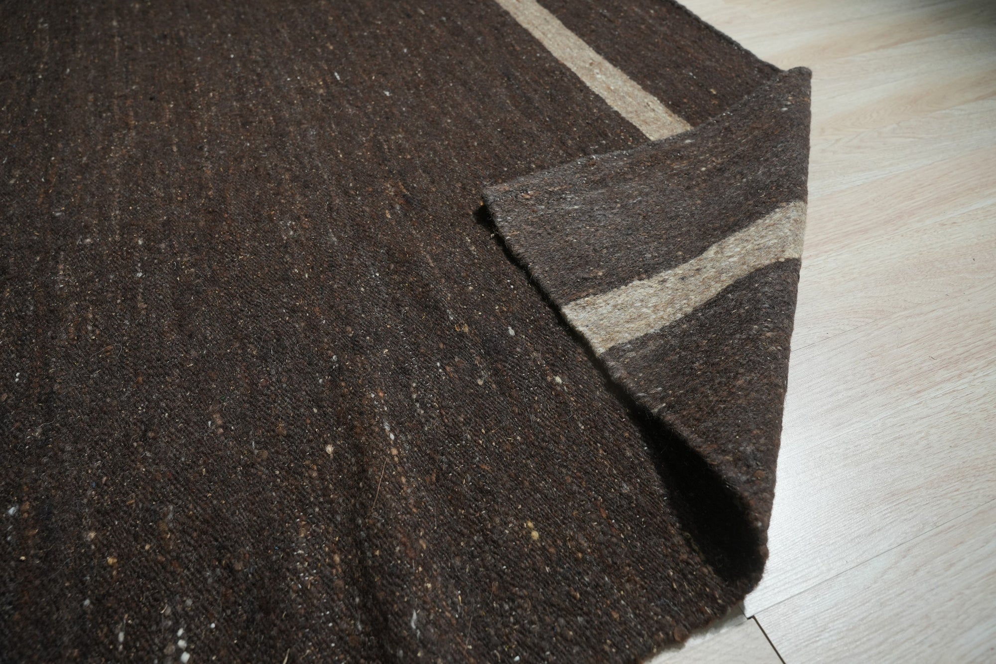 Violet Artistic Brown Flatweave Wool Rug, soft browns and muted violets blend in a contemporary flatweave, offering a subtle artistic touch to a modern living space with natural light.