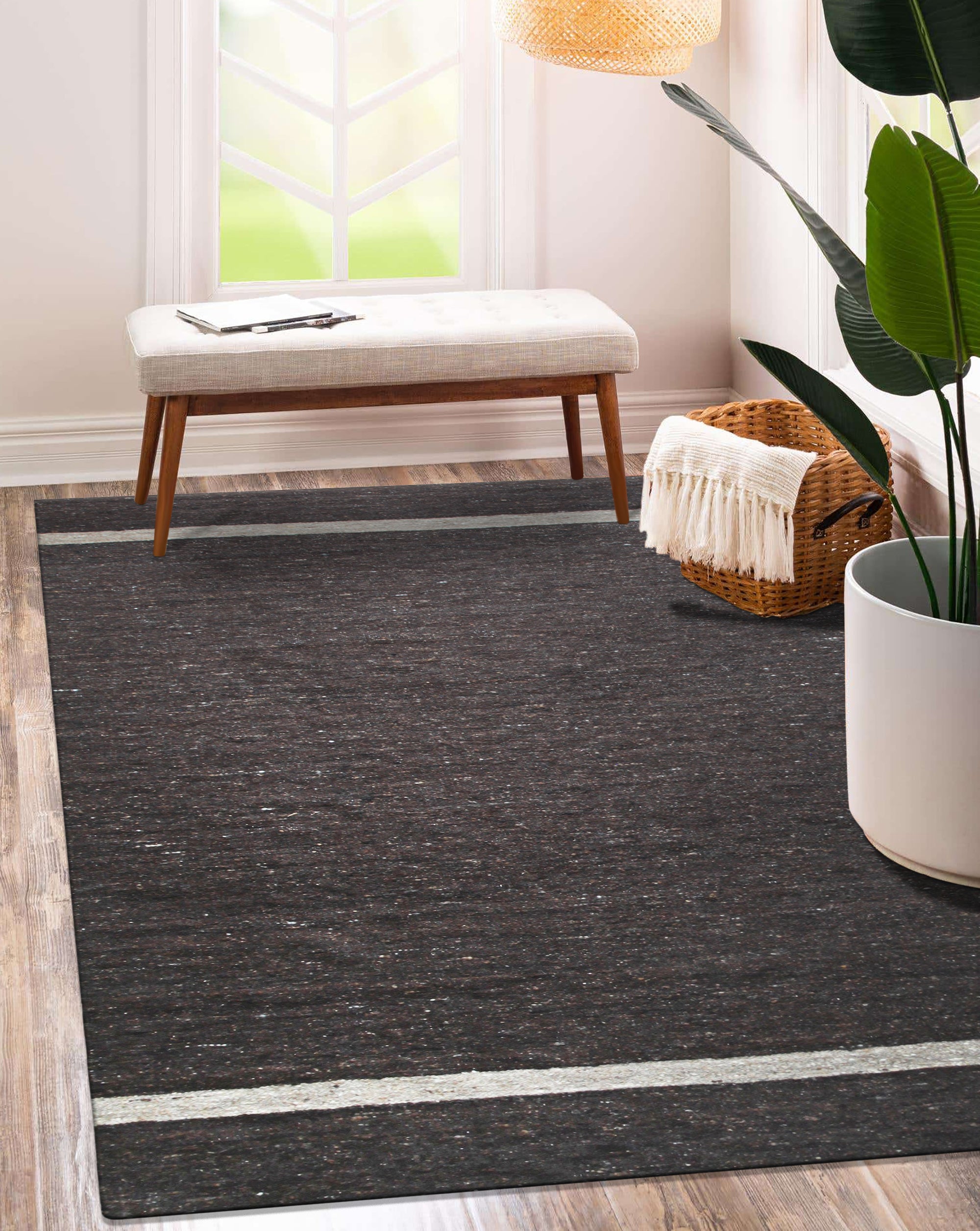 Violet Artistic Brown Flatweave Wool Rug in a bright, modern living room setting. Warm browns and violet accents blend in a flatweave wool construction, complementing the contemporary decor.