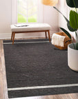 Violet Artistic Brown Flatweave Wool Rug in a bright, modern living room setting. Warm browns and violet accents blend in a flatweave wool construction, complementing the contemporary decor.